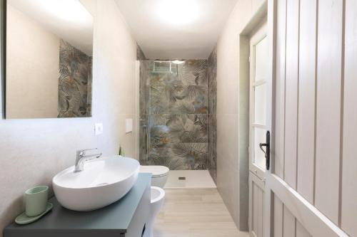 a bathroom with a sink and a toilet at Sea Breeze - Mare a 50mt & Terrazza Relax in Quartu SantʼElena