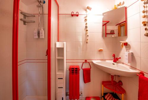 a small bathroom with a sink and a shower at Mansarda Vista Mare Nel Verde in Quercianella