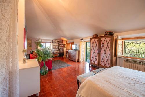a bedroom with a bed and a living room at Mansarda Vista Mare Nel Verde in Quercianella