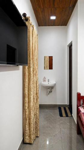 a bathroom with a sink and a shower curtain at DOWN TOWN HOLIDAYS Kovalam in Kovalam