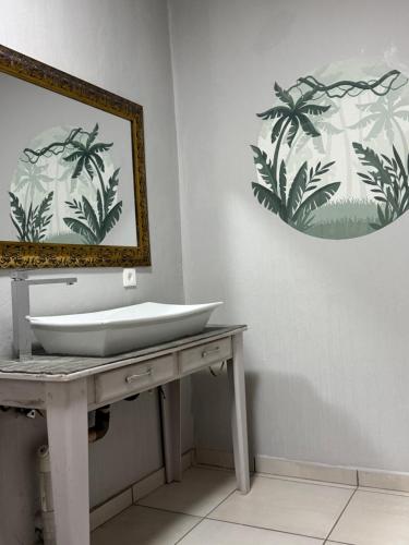 a bathroom with a sink and a mirror at The Chalant in Tzaneen