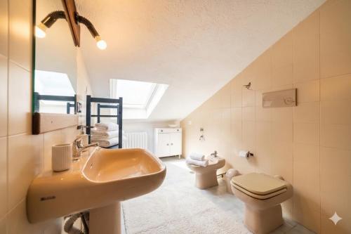 a bathroom with two sinks and a toilet in a attic at Casa Liselotte in Imperia