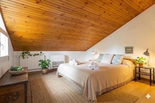 a bedroom with a large bed with a wooden ceiling at Casa Liselotte in Imperia