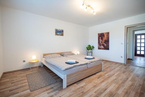 a large white bedroom with a large bed in it at Apartment Molnar in Žirovnica