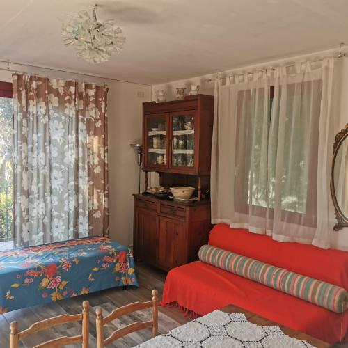 a living room with a couch and a chair at Casa Nel Verde Vista Mare in Quercianella