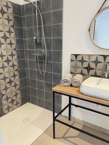 a bathroom with a shower and a sink at La Secrète in Vogüé