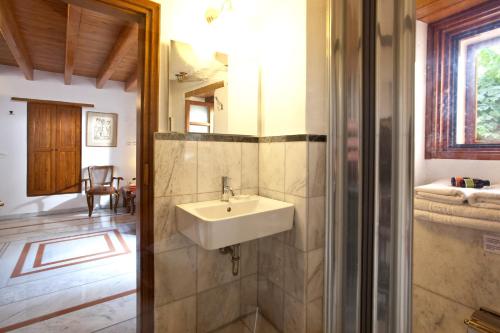 a bathroom with a sink and a mirror at Theophano Art Hotel in Monemvasia