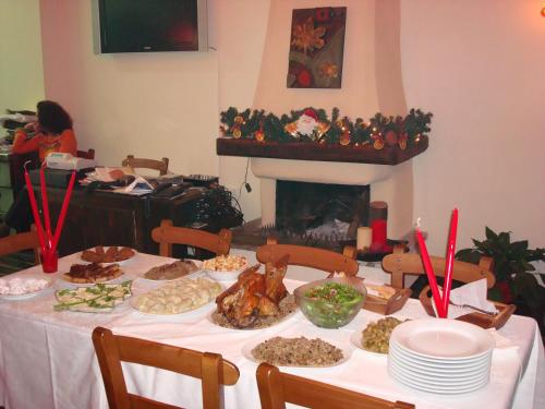 a table with food on it with a fireplace at Guesthouse Amanitis Caesarea in Skíti