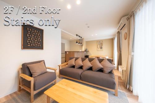 a living room with a couch and a table at Kitasaito Terrace C in Asahikawa