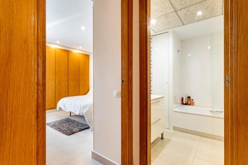 a bedroom with a bed and a tub in a room at Patacona By The Beach in Valencia