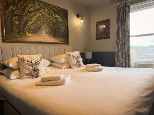a bedroom with a bed with towels on it at The Royal Oak Ripon in Ripon