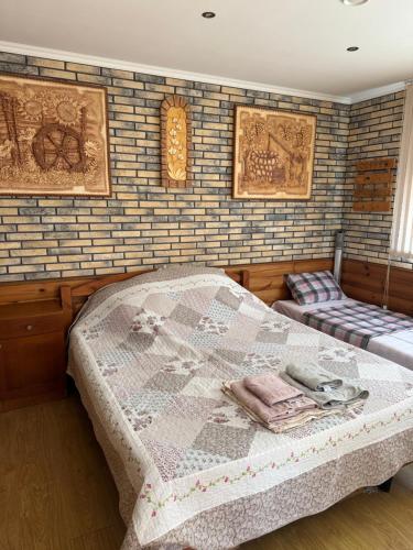 a bedroom with a bed with a quilt on it at Будиночок для відпочинку in Odesa