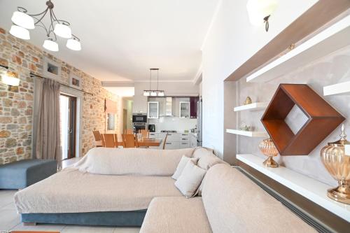 a living room with a couch and a dining room at Villa Selas Kalymnos in Kalymnos