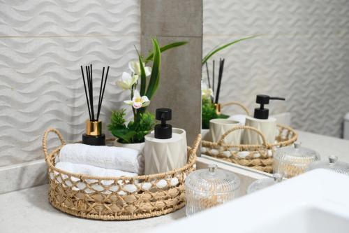 a bathroom counter with baskets of towels and a mirror at Villa Selas Kalymnos in Kalymnos