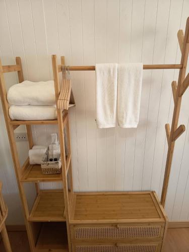 a bathroom with a towel rack with towels at The big market Resort in Jomtien Beach