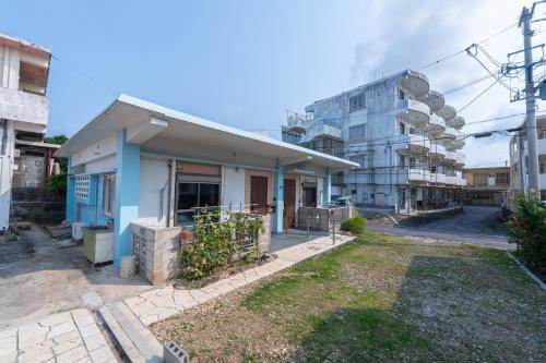 a small house in front of a building at ヴィラ結Miyakojima2 in Miyako-jima