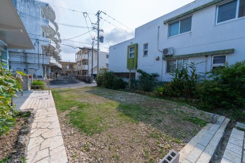 an empty street in a city with buildings at ヴィラ結Miyakojima2 in Miyako-jima