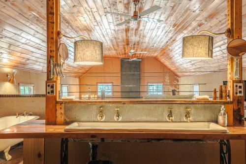 a bathroom with a sink and a large mirror at The Barn Daylesford in Daylesford