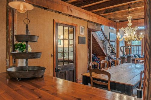 a dining room with a large wooden table and a dining room table at The Barn Daylesford in Daylesford