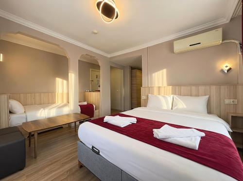 a hotel room with a large bed and a desk at Le Safran Palace in Istanbul