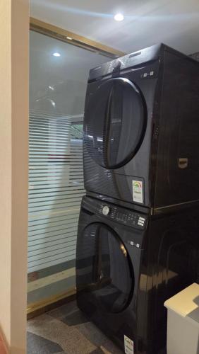 a microwave oven sitting on top of a refrigerator at Mora Stay in Busan