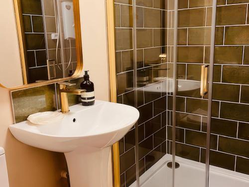 a bathroom with a sink and a shower at The Hideaway in Tintagel