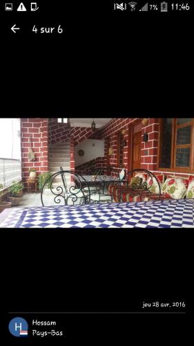 a picture of a group of benches in front of a building at Kasabah Senhaji in Moulay Idriss Zerhoun