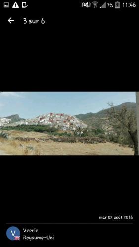a screenshot of a website with a picture of a mountain at Kasabah Senhaji in Moulay Idriss Zerhoun