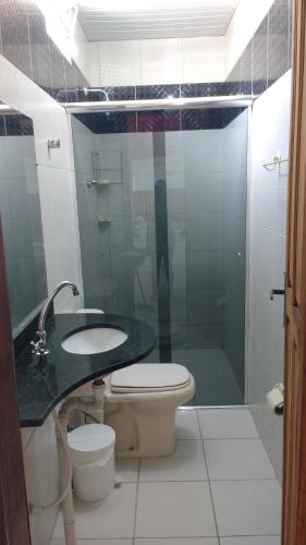 a bathroom with a sink and a toilet and a shower at Solo Nunes in Manaus