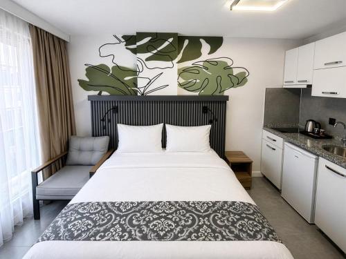 a bedroom with a large bed and a kitchen at D'Premium in Edirne