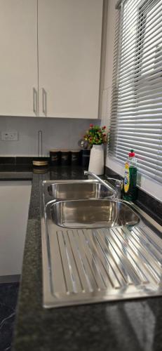 a kitchen counter with a sink in a kitchen at Minnestayairbnb in Gaborone