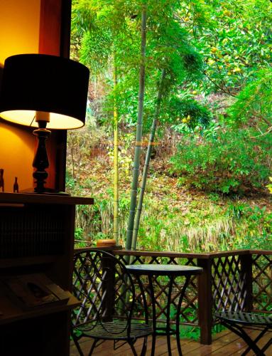 a lamp sitting on a porch with a table and chairs at Hoshi Meguri in Shimoda