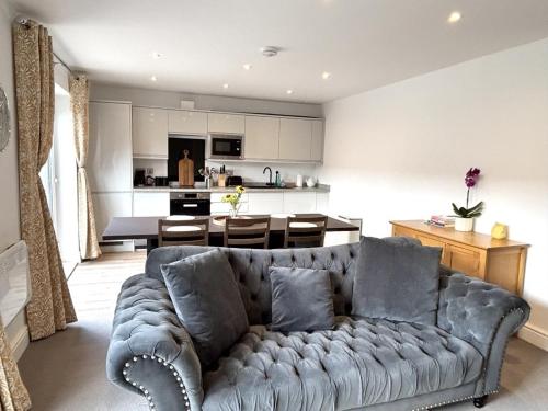 a living room with a couch and a kitchen at Smithy Mills in Halifax