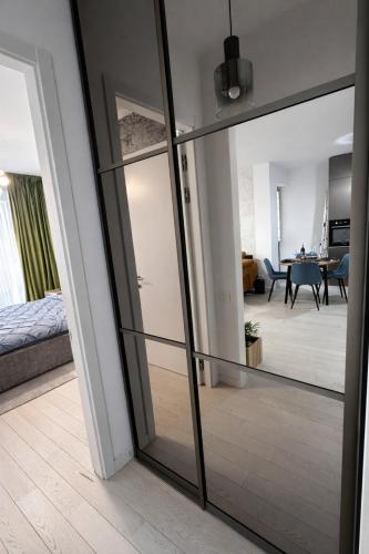 a room with a glass door leading to a living room at Herastrau Prestige Apartment WIN in Bucharest