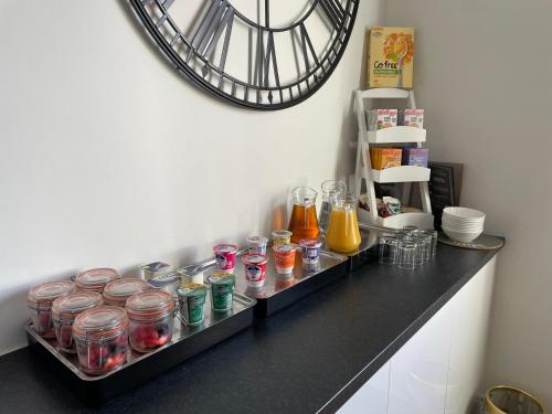 a counter with jars of food and a clock on the wall at Dolly Waggon Guest House in Keswick
