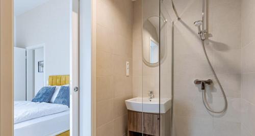 a bathroom with a shower and a sink at A60 Apartment Hotel in Budapest