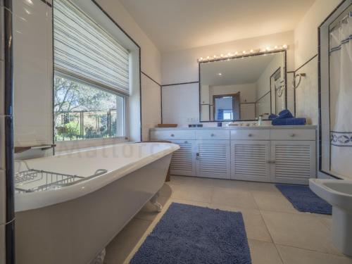 a bathroom with a tub and a sink and a mirror at M4R 03 Villa Maracanda, Banyalbufar in Banyalbufar