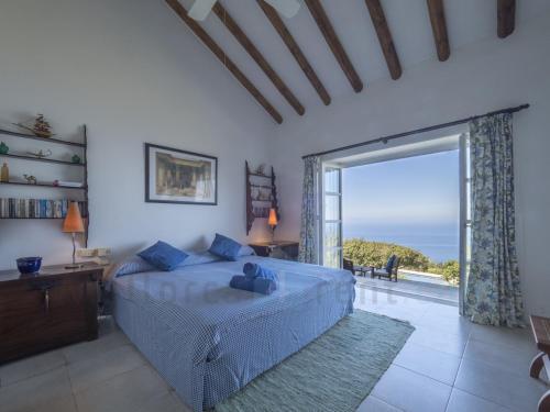 a bedroom with a bed and a large window at M4R 03 Villa Maracanda, Banyalbufar in Banyalbufar