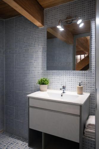 a bathroom with a white sink and a mirror at Maisonnette avec piscine - sud Ardèche in Saint-Montan