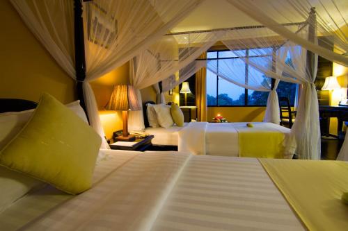 a bedroom with two beds and a window at Pacific Hotel & Spa in Siem Reap