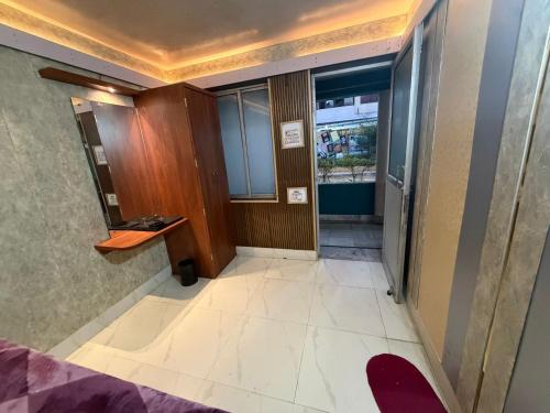 a hallway of a building with a door and a room at Silver Lake View Resort in Barhi