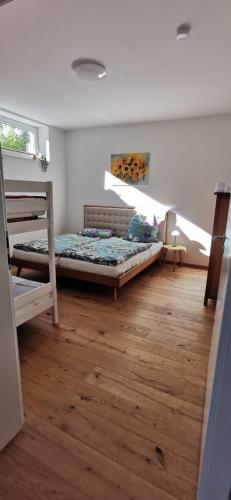 a bedroom with two bunk beds and a wooden floor at Rheinufer in Xanten