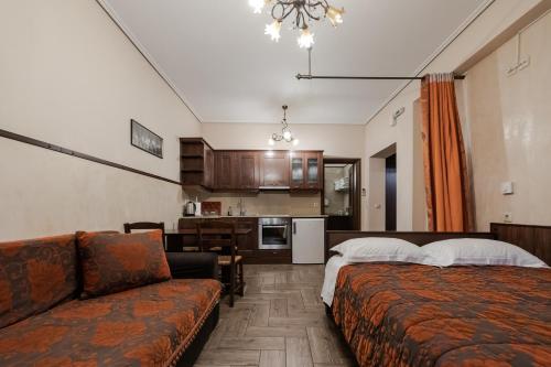 a living room with a couch and a kitchen at Alsos House in Kalabaka