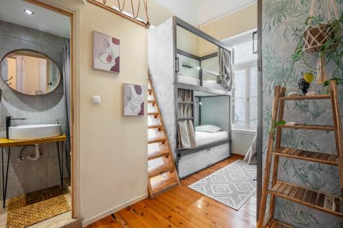 a room with a bunk bed and a bathroom at Baloo Hostel in Athens