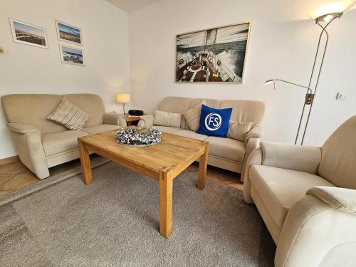 a living room with a couch and a table at Reihenhaus Donna in Dahme