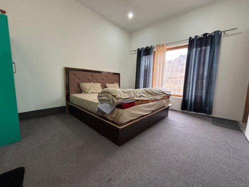 a bedroom with a bed and a window at Dod gu Yongs Khil in Karu