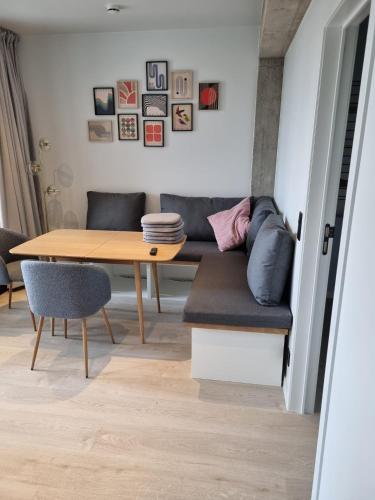 a living room with a table and a couch at Homey Kortrijk L29 in Kortrijk
