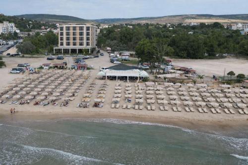 an aerial view of a beach with a large group of cars at Hotel Magnific in Kranevo
