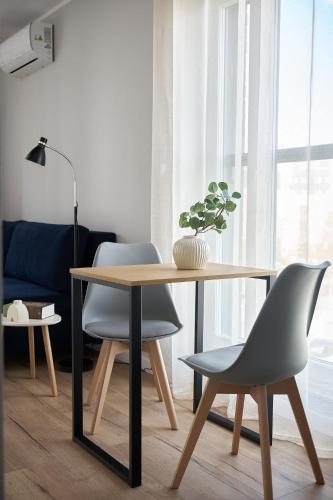 a dining room with a table and two chairs at Symphony City Square Aparthotel by INA in Wrocław