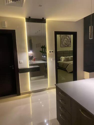 a kitchen with a large mirror and a living room at Abdali Views Luxury Suite in Al Jafr
